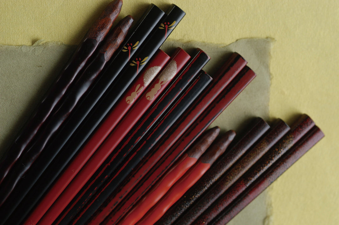 Various authentic Japanese lacquerware chopsticks with traditional patterns, designed to be dishwasher safe.